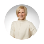 Dr. Kerri Treherne smiling in a white sweater in a professional headshot