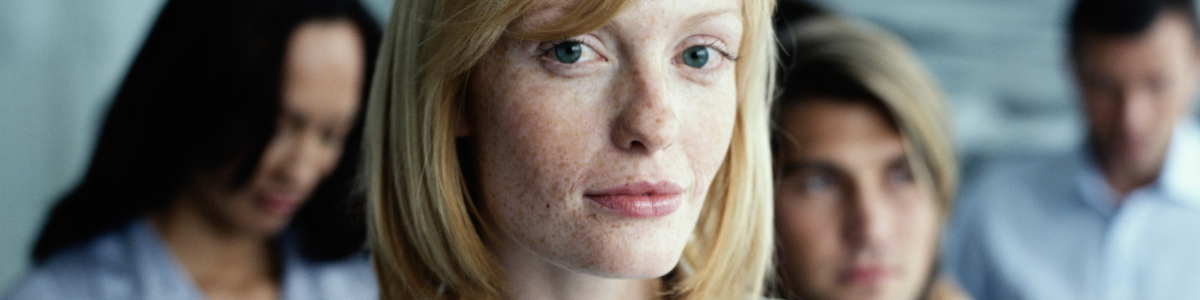 A blonde woman with freckles, with lived experience, in a peer group. 