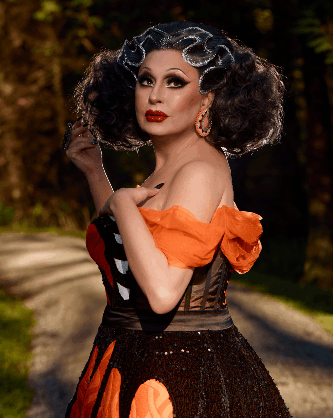 Portrait of Jaylene Tyme, wearing an orange dress in honour of the National Day for Truth and Reconciliation